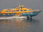 a flying dolphin passes our boat in calm seas only