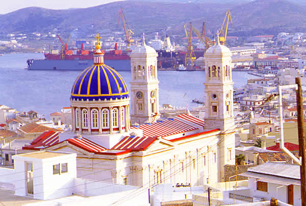 a close up view of Syros harbor with cathedral