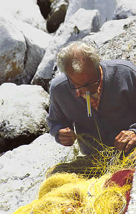 a fisherman mending his nets