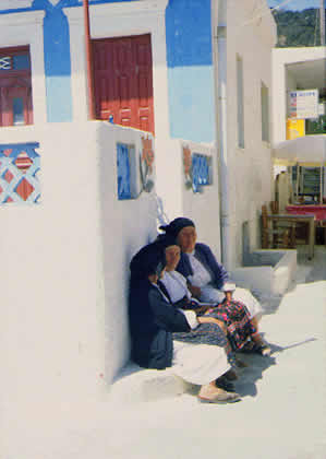 three ladies in the shade of sidewalk