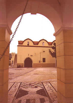 an arch with a stone mosaic floor in front of it